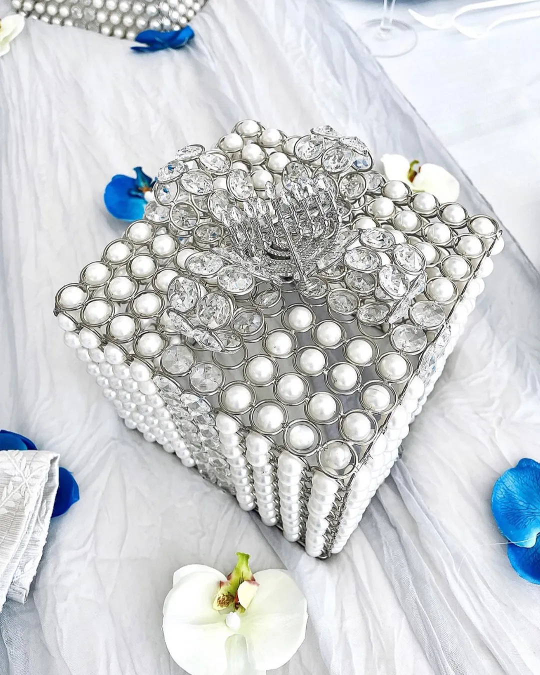 Pearl and crystal beaded box with a small silver menorah on top, close up