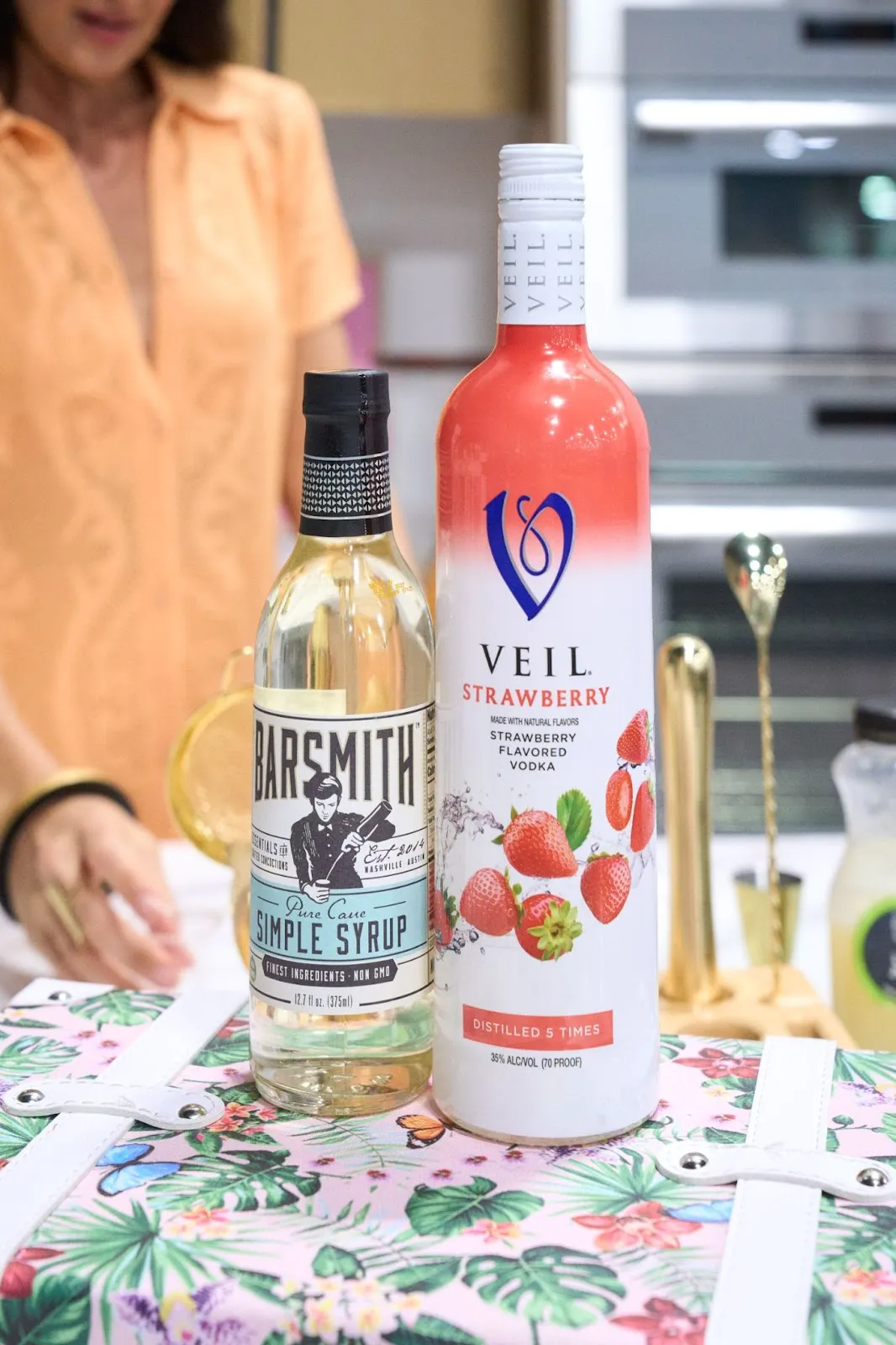Barsmith simple syrup and Veil Strawberry vodka bottles on a bar cart