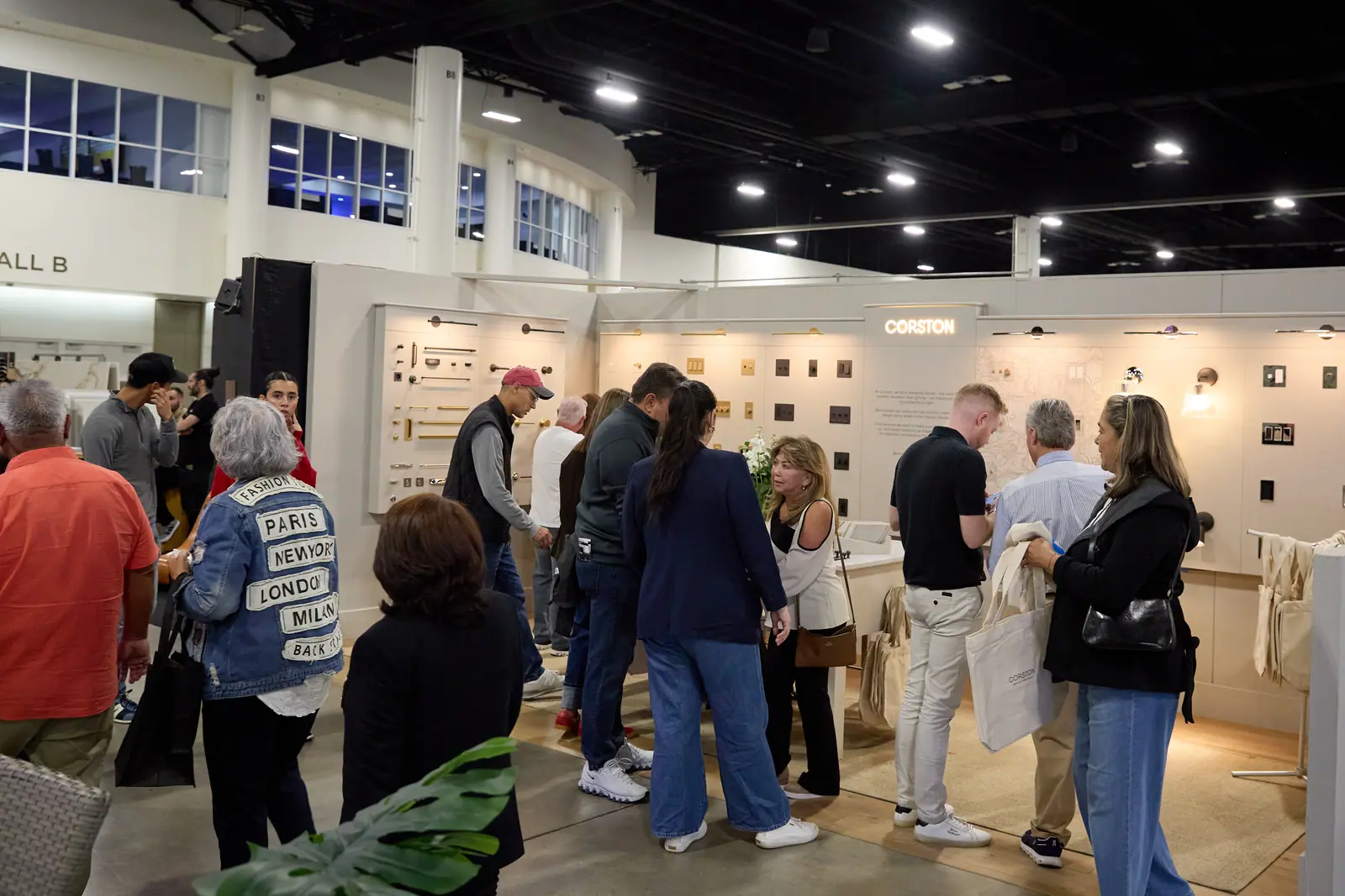 Corston hardware and fixture booth packed with attendees examining wall displays at the home show