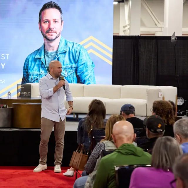 Drew Lachey addresses a seated audience from the Home Design and Remodeling Show stage