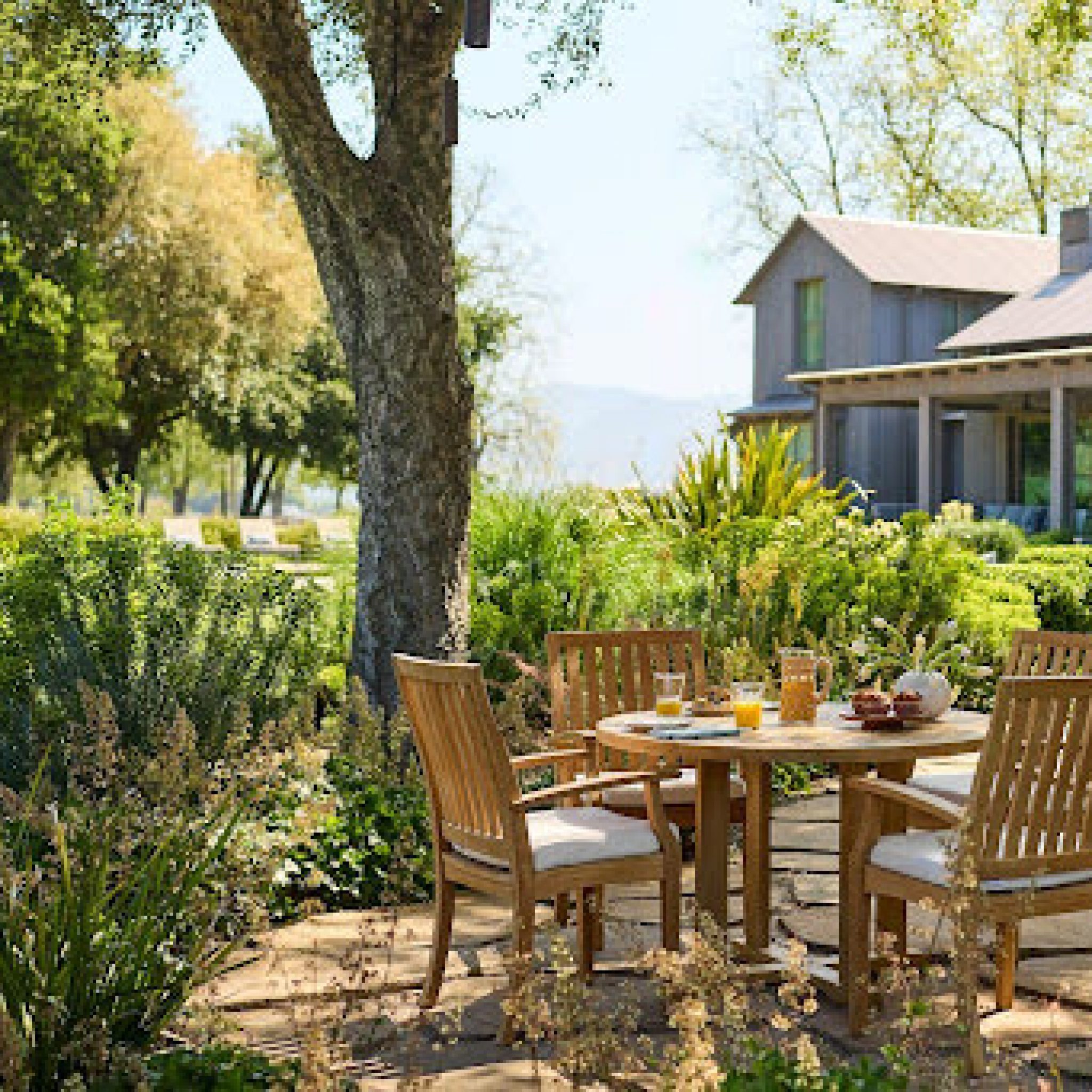 Outdoor patio dining set surrounded by greenery featured at the Home Design and Remodeling Show.
