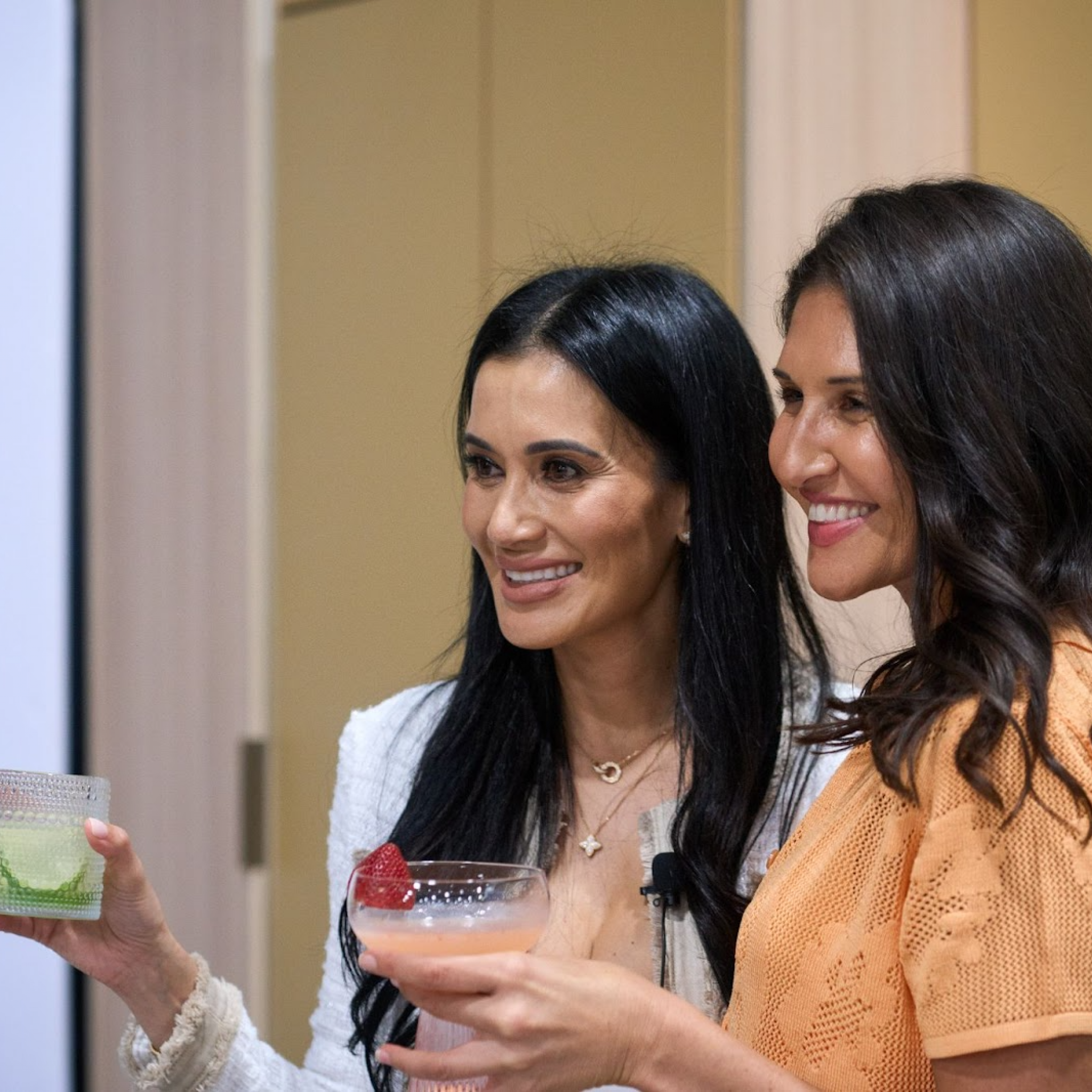Two women smiling and enjoying drinks at the Home Design and Remodeling Show’s culinary event.